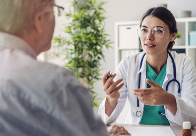 University Hospitals Birmingham doctor communicating with an elderly patient
