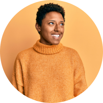 Client is stand against an orange backdrop and is smiling as she is happy with the service 