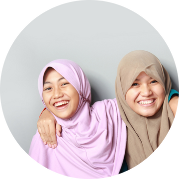 Two Asian girls in headscarf's smiling as they got the help they needed from Ovacome Two Asian girls in headscarf's smiling as they got the help they needed from Ovacome