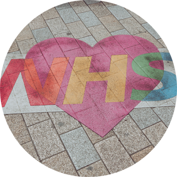 Street art of a rainbow NHS logo in a heart 