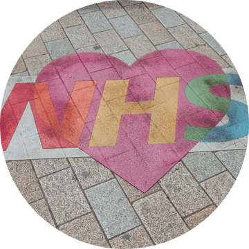 Street art of a rainbow NHS logo in a heart Street art of a rainbow NHS logo in a heart
